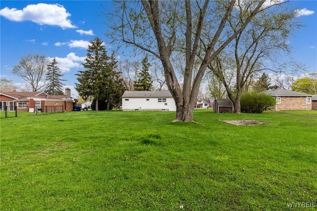 view of yard with an outdoor structure and a storage shed