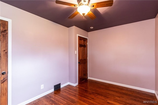 unfurnished room featuring ceiling fan, baseboards, visible vents, and dark wood finished floors