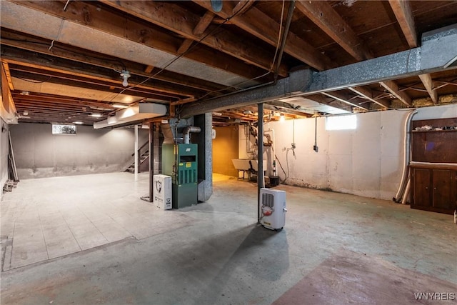 below grade area with heating unit and a sink