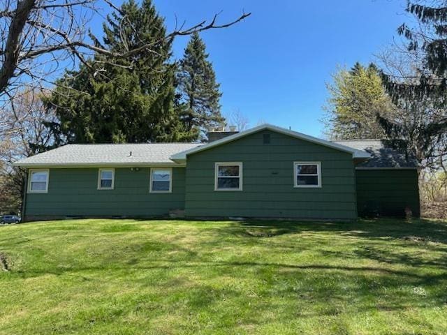 back of house with a lawn