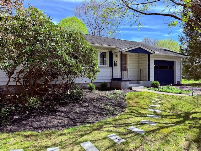 ranch-style home with a garage, a front yard, and a shingled roof