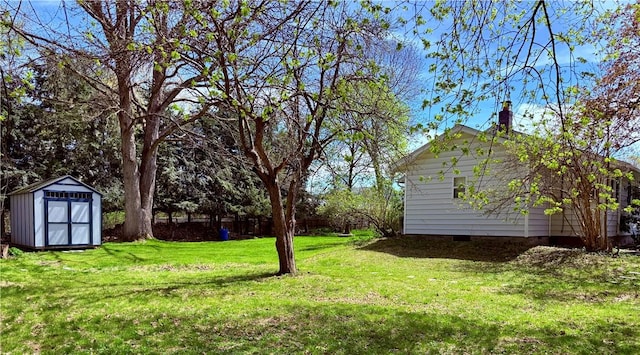 view of yard with a storage unit and an outbuilding