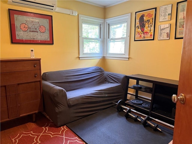 sitting room with crown molding and an AC wall unit