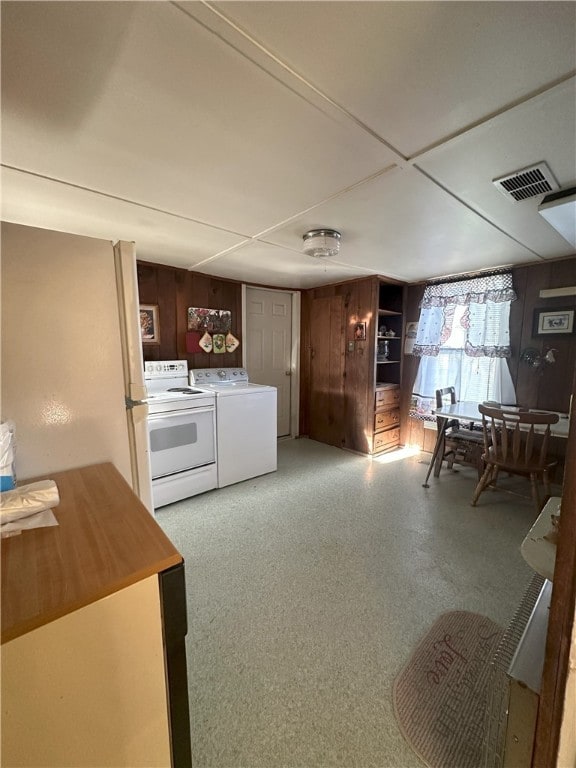 16 School St, Moravia, NY 13118 - interior space featuring visible vents, wooden walls, and washing machine and clothes dryer