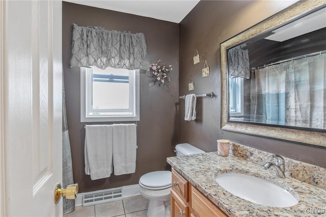 bathroom with visible vents, vanity, toilet, baseboards, and tile patterned floors