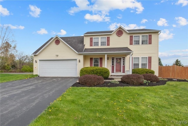 traditional home with covered porch, aphalt driveway, fence, a front lawn, and an attached garage