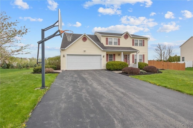 traditional home with aphalt driveway, fence, a front yard, and a garage