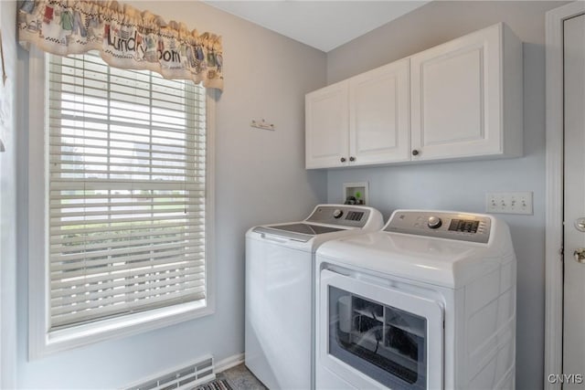 washroom featuring cabinet space and washer and dryer