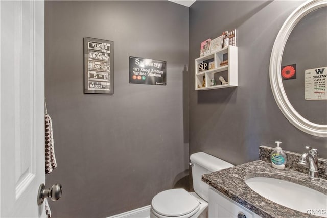 half bath featuring toilet and vanity