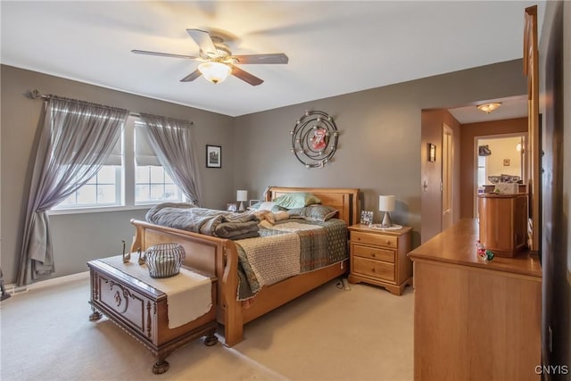 bedroom featuring ceiling fan and light carpet