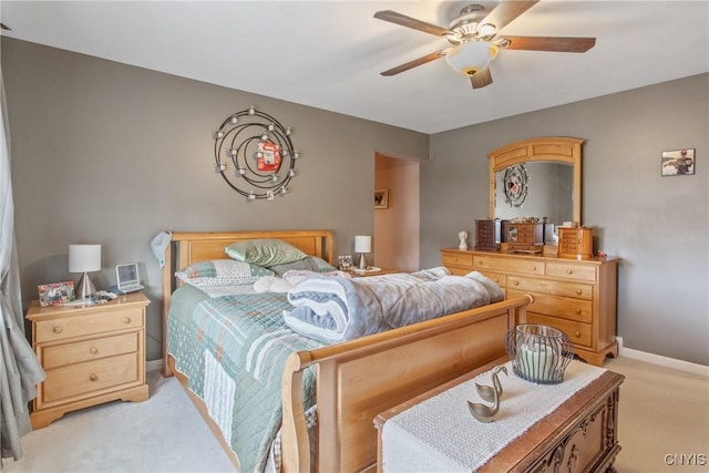 bedroom with baseboards, ceiling fan, and light colored carpet