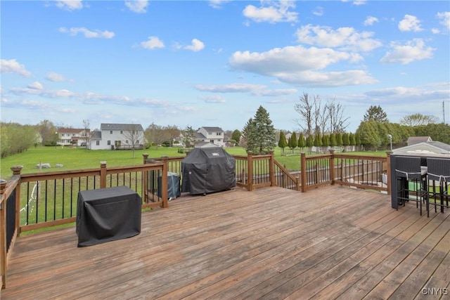 deck featuring a yard and grilling area