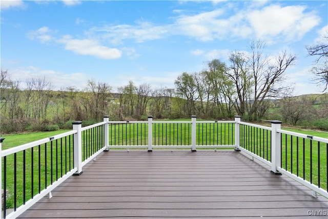 wooden terrace featuring a lawn