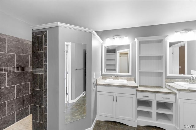 bathroom with tiled shower and vanity