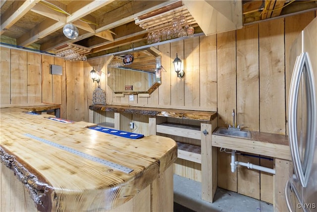 bar with wooden walls and freestanding refrigerator