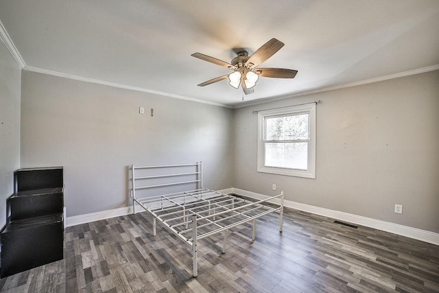 unfurnished bedroom with crown molding, baseboards, and wood finished floors