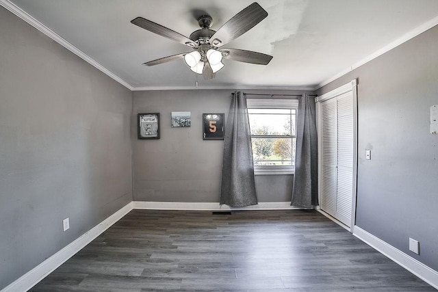 unfurnished room with crown molding, baseboards, ceiling fan, and wood finished floors