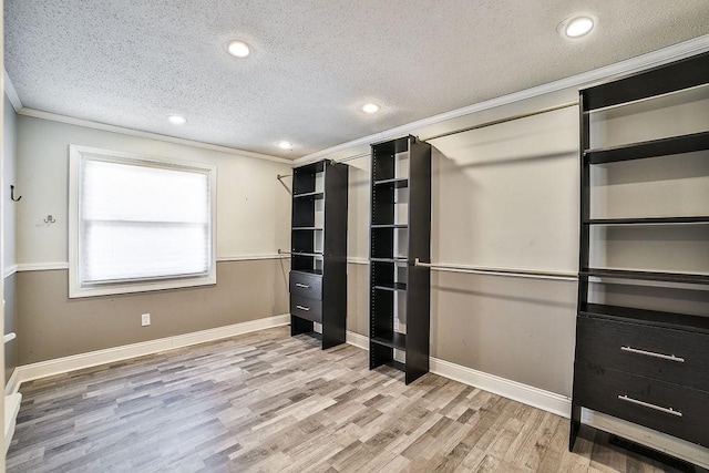 unfurnished bedroom featuring crown molding, recessed lighting, a textured ceiling, and wood finished floors