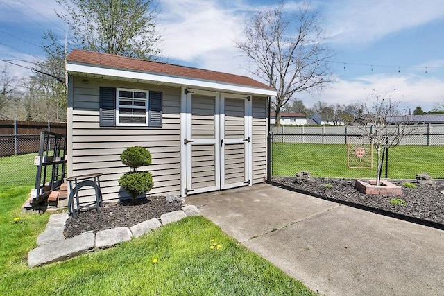 view of outdoor structure featuring fence and an outbuilding
