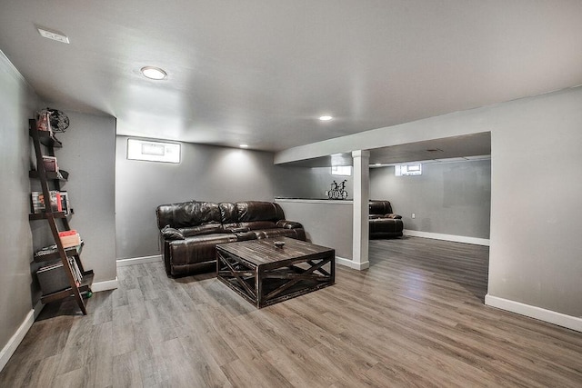 living room featuring recessed lighting, baseboards, a wealth of natural light, and wood finished floors