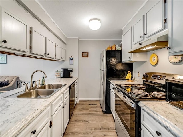kitchen with crown molding, appliances with stainless steel finishes, light wood-type flooring, a sink, and under cabinet range hood