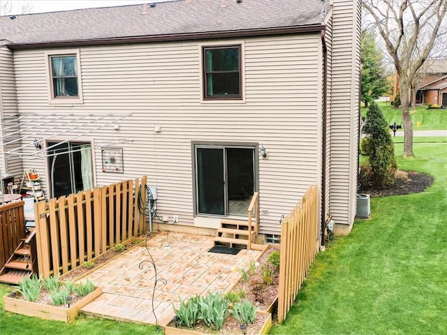 rear view of property with a wooden deck, a shingled roof, a patio area, entry steps, and a yard