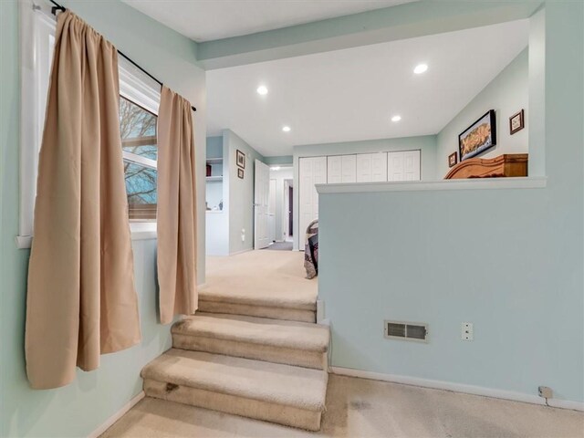 interior space with carpet floors, recessed lighting, baseboards, and visible vents