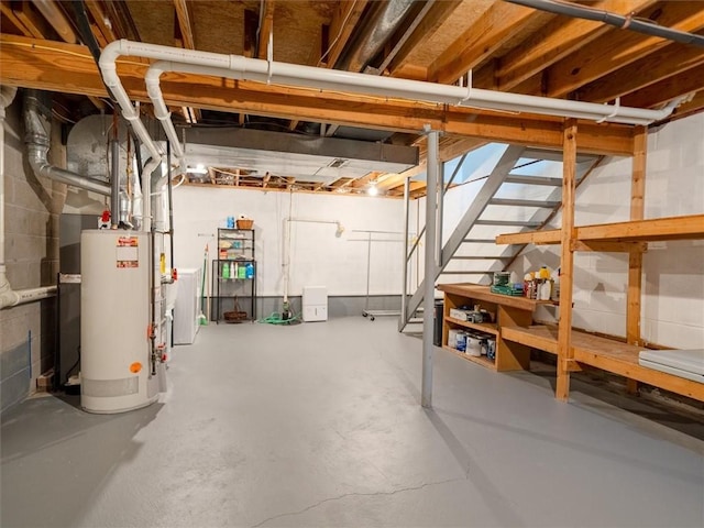 unfinished basement with stairs and water heater