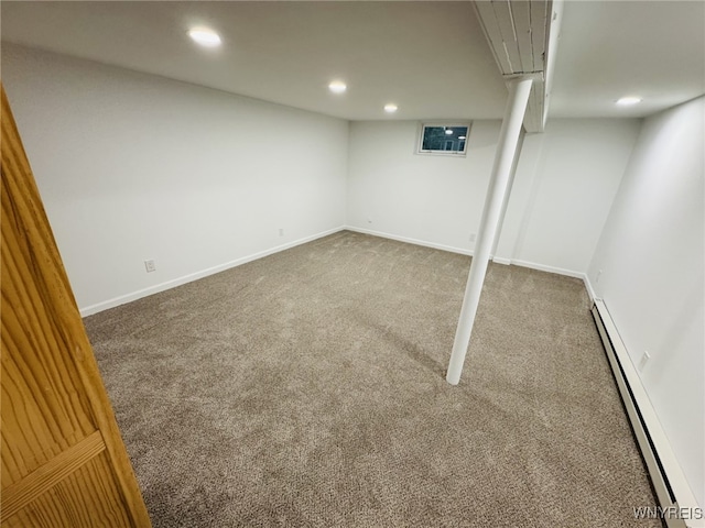 finished below grade area with carpet floors, a baseboard radiator, baseboards, and recessed lighting