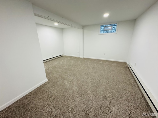 below grade area featuring carpet floors, baseboards, and baseboard heating
