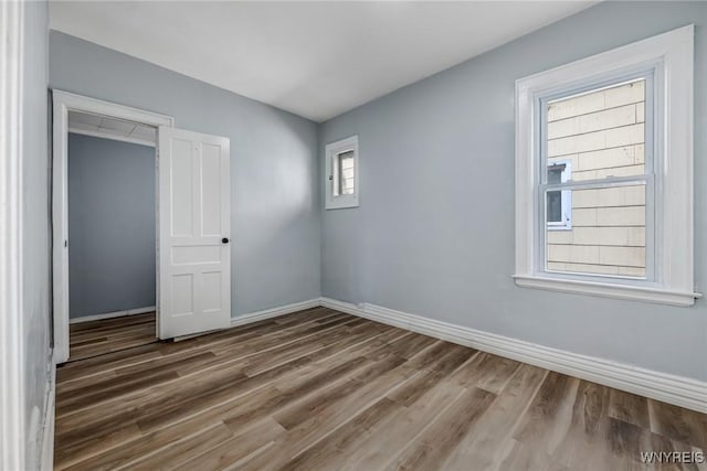 unfurnished bedroom featuring baseboards and wood finished floors