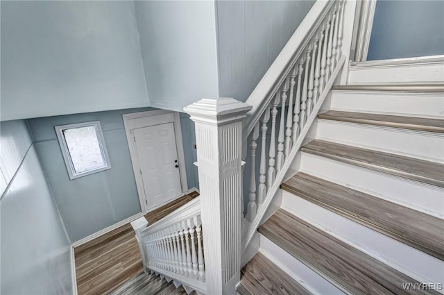 stairway with wood finished floors