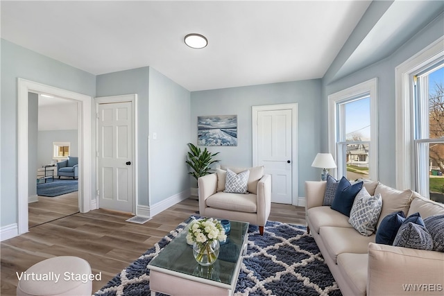living room featuring baseboards and wood finished floors