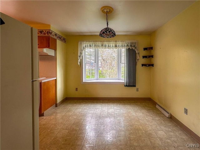 unfurnished dining area with baseboards and baseboard heating