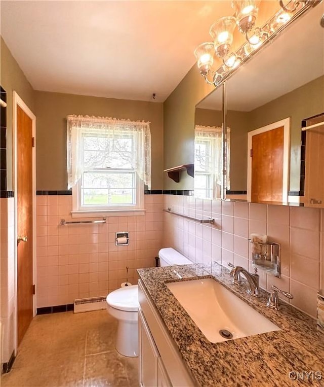 bathroom featuring tile walls, a baseboard heating unit, tile patterned floors, and toilet