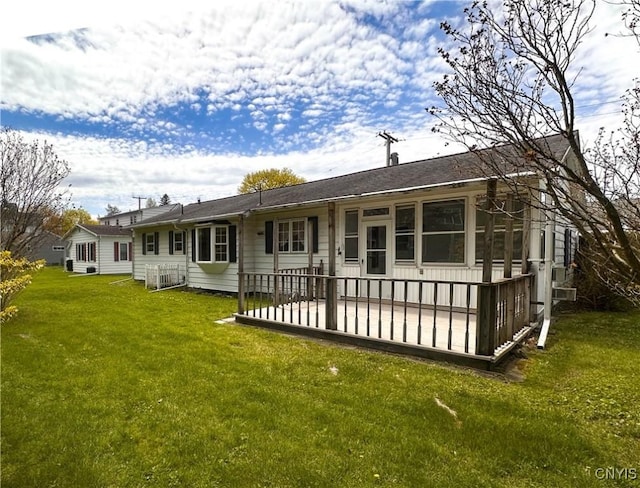 back of property featuring a lawn