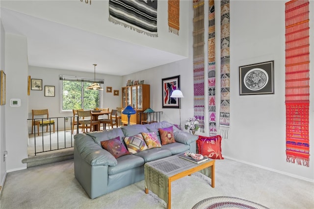 carpeted living area with baseboards