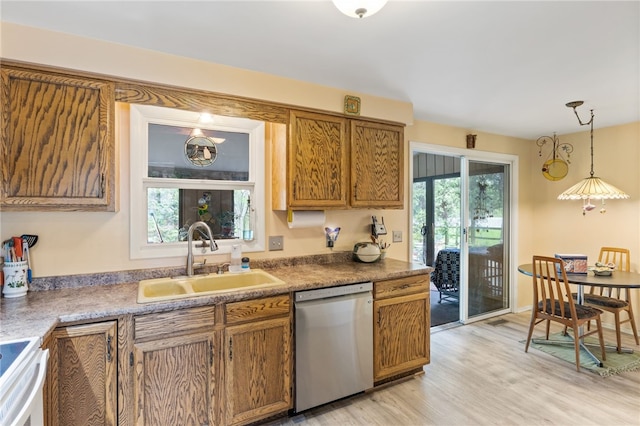 kitchen featuring brown cabinetry, a sink, light wood-style flooring, dishwasher, and hanging light fixtures