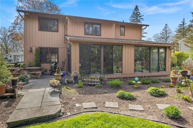 back of house featuring a sunroom and a patio area
