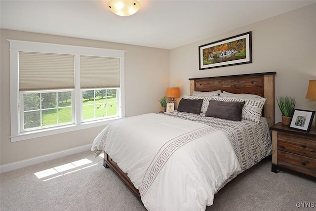 carpeted bedroom featuring baseboards