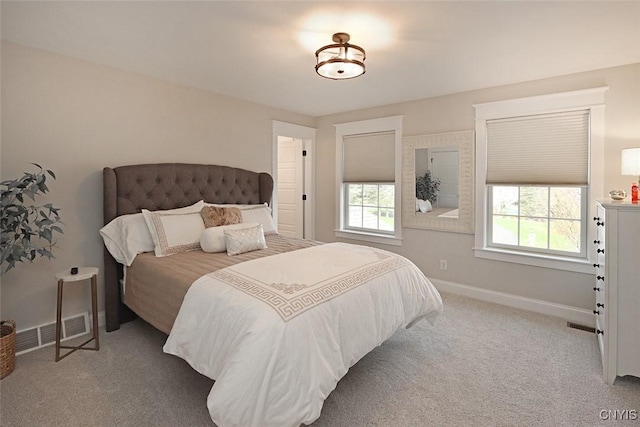 bedroom featuring baseboards, carpet flooring, and visible vents