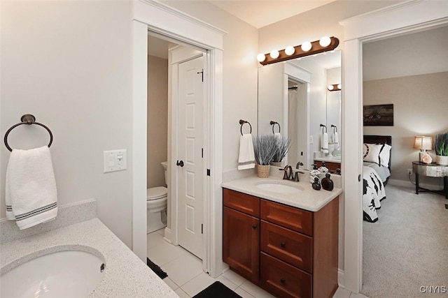 ensuite bathroom featuring toilet, ensuite bathroom, and vanity