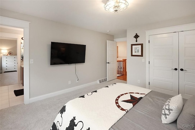 bedroom with baseboards, carpet, a closet, and visible vents