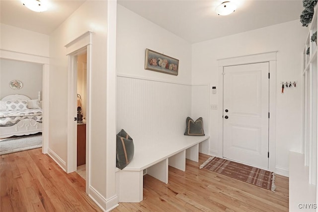 mudroom featuring wainscoting and light wood finished floors