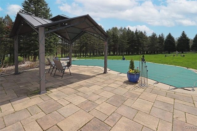 view of swimming pool featuring a lawn, a gazebo, and a patio area