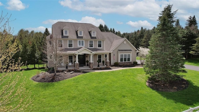 view of front of house with a porch and a front lawn