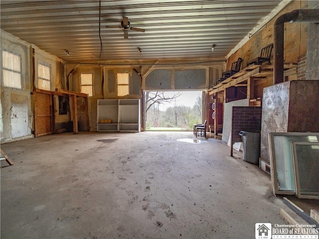 5585 Eke Rd, Harmony, NY 14710 - miscellaneous room featuring ceiling fan, concrete flooring, and a garage