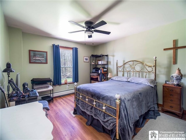 5585 Eke Rd, Harmony, NY 14710 - bedroom with a baseboard radiator, ceiling fan, and wood finished floors