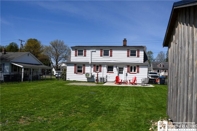 17 Howard St, Carroll, NY 14738 - rear view of house featuring a lawn, a patio, fence, and a chimney
