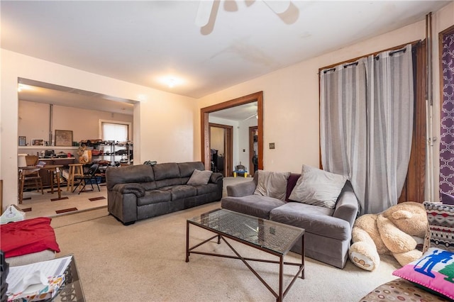 carpeted living room featuring ceiling fan
